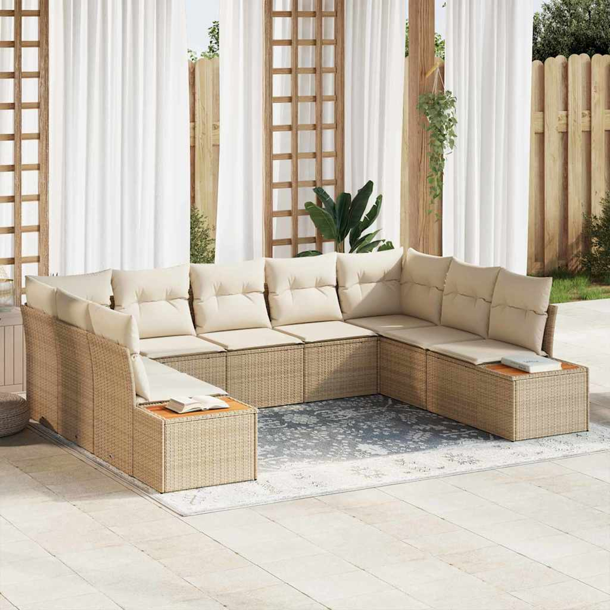 Ein U-förmiges Outdoor-Sofa mit beigen Kissen steht auf einem Teppich. Weiße Vorhänge, Holzgitter und Zaun bilden den Hintergrund.