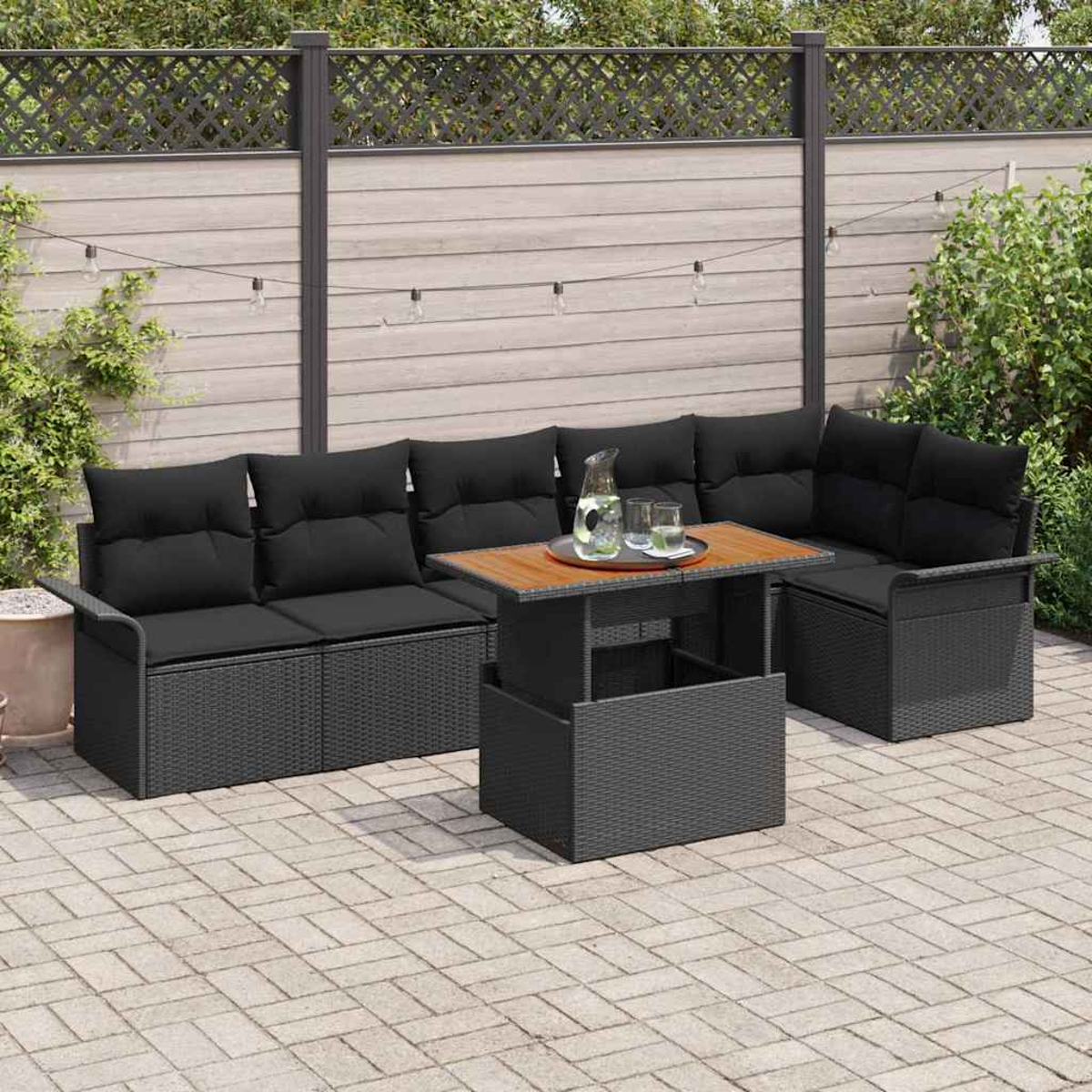 Gartenmöbel-Set mit schwarzen Kissen und Holztisch. Szene auf Steinpflaster mit Holzzaun im Hintergrund.