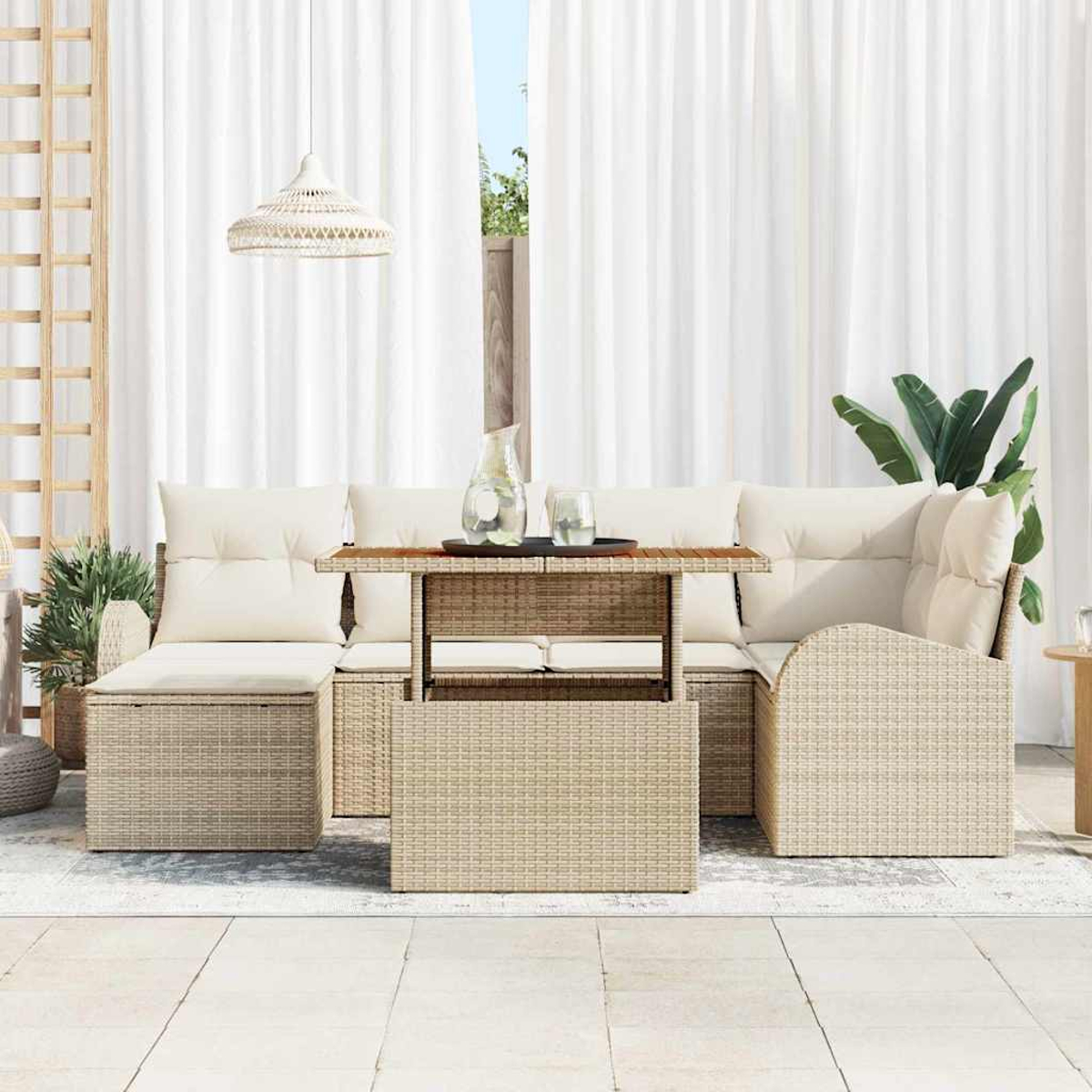 Gartenmöbel-Set aus Korbgeflecht mit beigen Kissen. Mit Tisch mit Holzplatte, Sofa und Hängelampe. Weiße Vorhänge im Hintergrund.