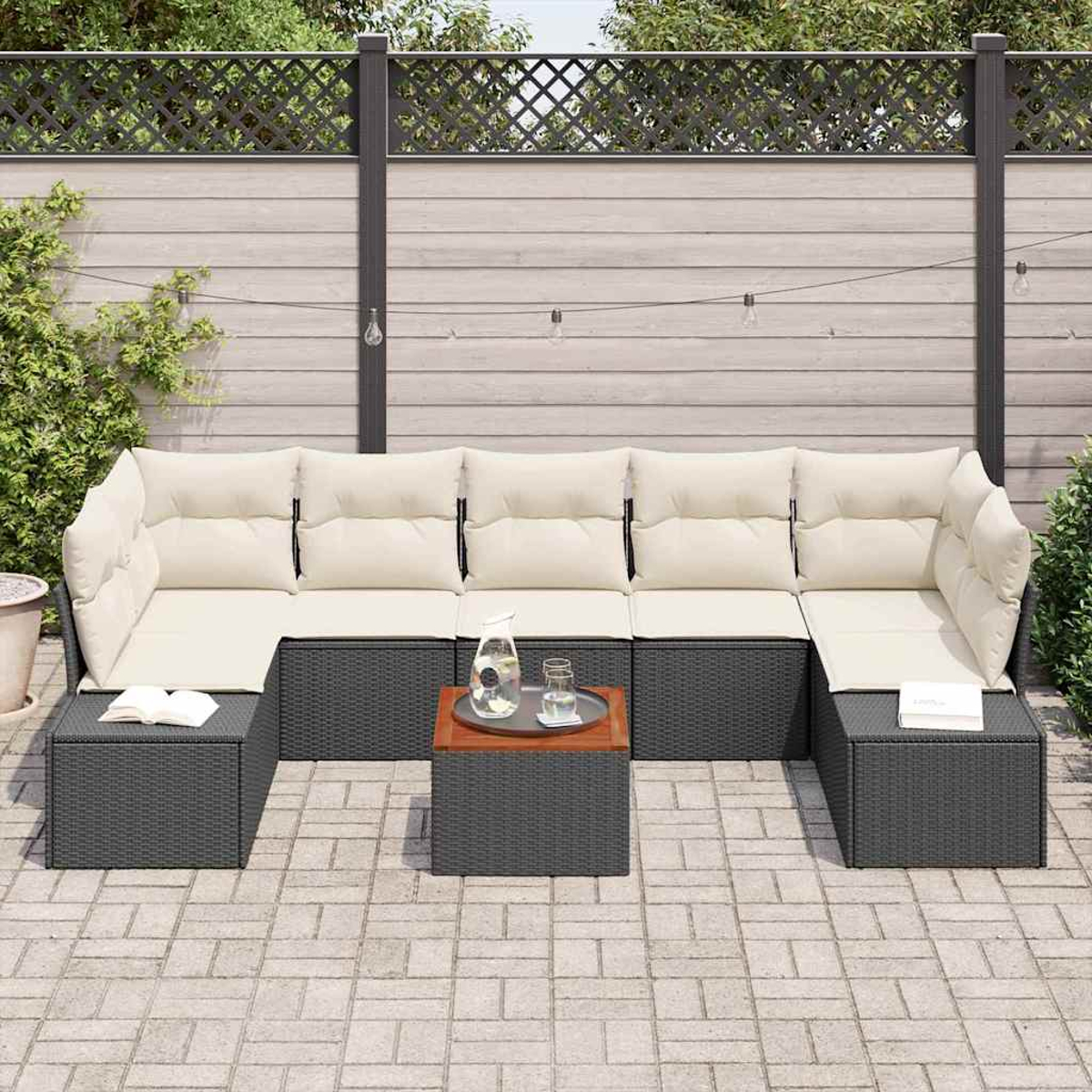 Outdoor-Ecksofa mit beigefarbenen Kissen und dunkelgrauer Korbbasis. Ein kleiner Tisch mit einer Glaskanne steht auf einer Terrasse.