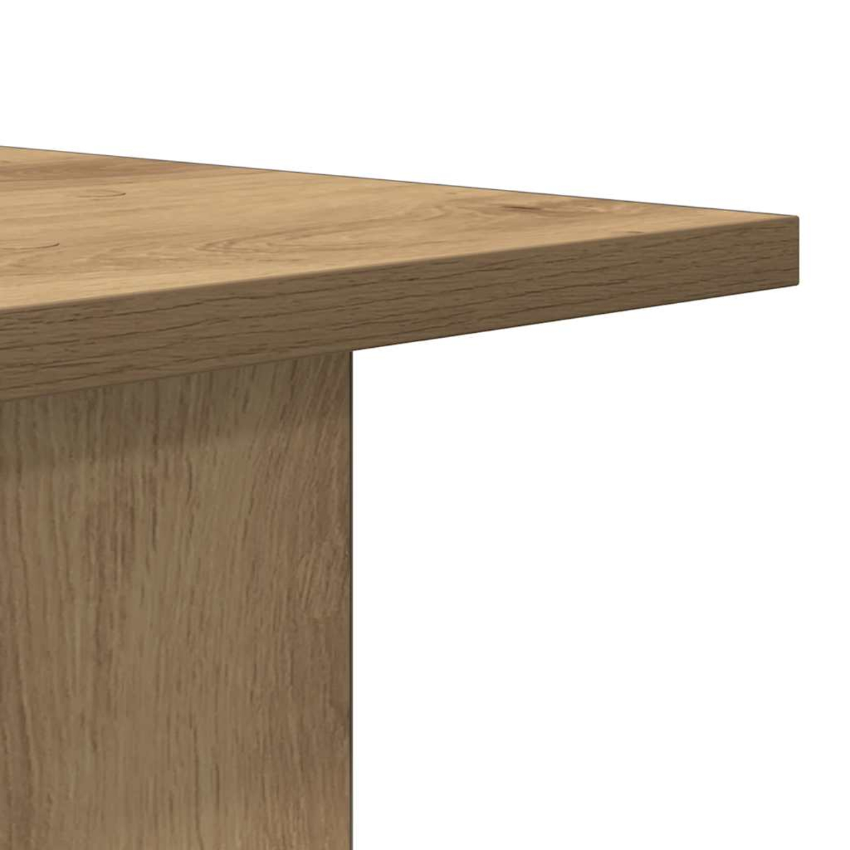 Nahaufnahme einer hellbraunen Holztischecke. Der Tisch hat eine dicke, strukturierte Oberfläche und ein Stützbein.