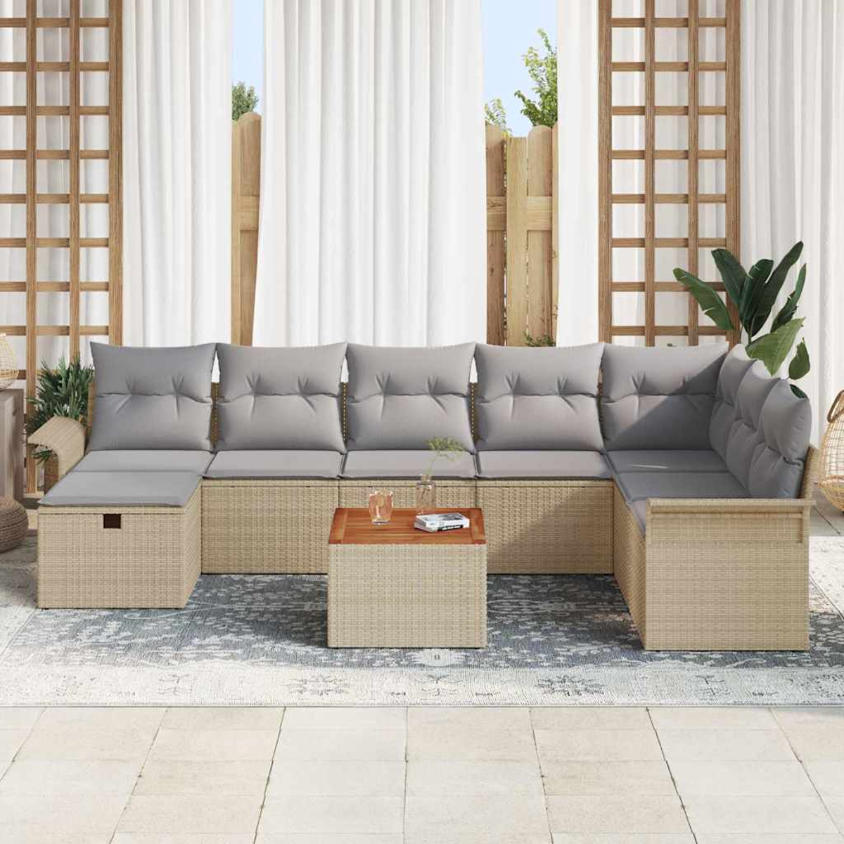 Sofá seccional para exteriores con cojines grises y una mesa de centro de madera. Detrás, cortinas blancas y una valla de madera.