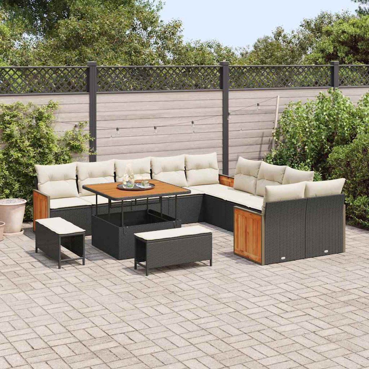 Divano angolare da esterno con cuscini beige e dettagli in legno, tavolo nero e panche su un patio in mattoni. Recinzione e alberi sullo sfondo.