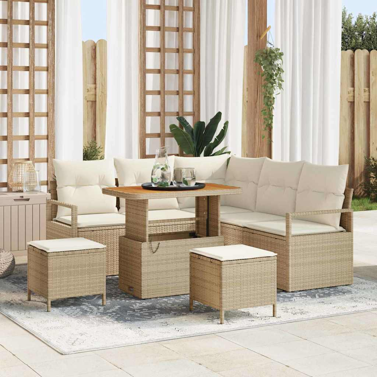 Terrassenset mit beigen Korbmöbeln, Sofa, zwei Stühlen, Ottomanen und Tisch, auf gemustertem Teppich, mit weißen Vorhängen.