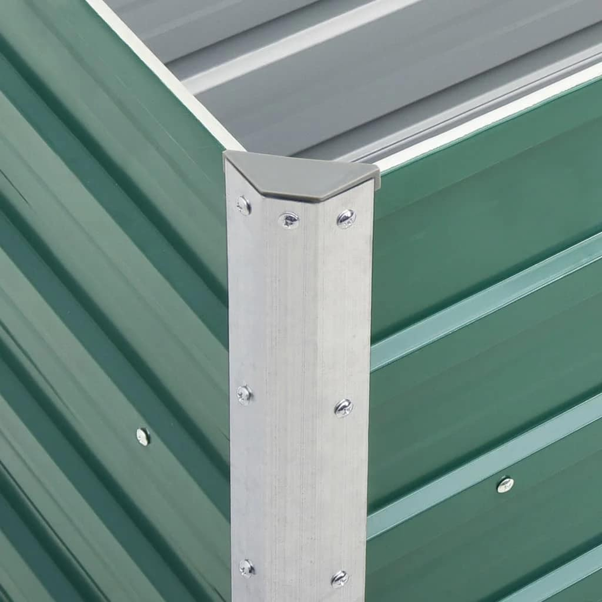 Eine Metallecke einer grünen Struktur mit silbernen Nieten und einer grauen Eckkappe. Der Hintergrund zeigt das Innere der Struktur.