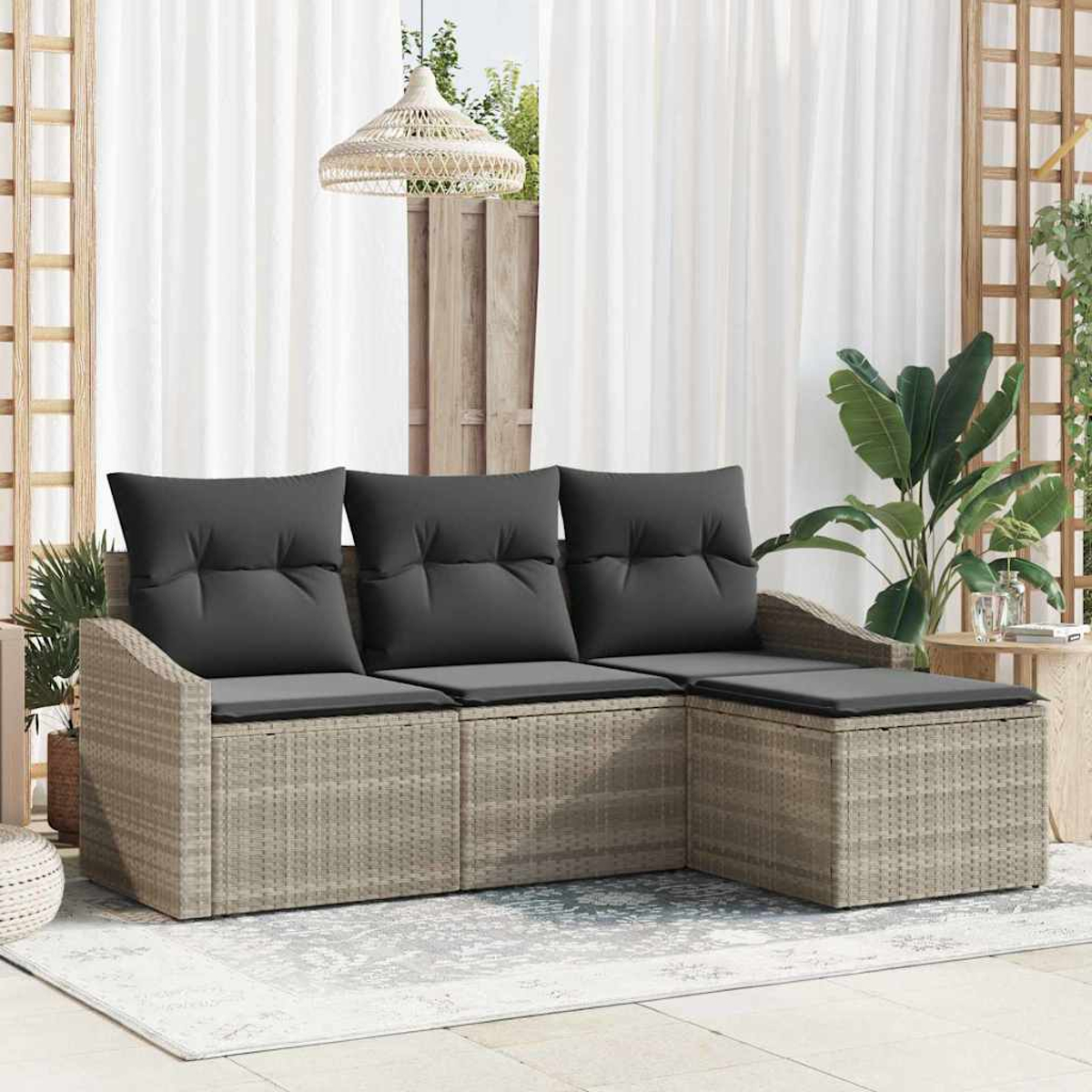 Outdoor-Ecksofa mit grauen Kissen. Beigefarbener Korbrahmen. Weiße Vorhänge, Pflanzen und ein gewebter Lampenschirm im Hintergrund.