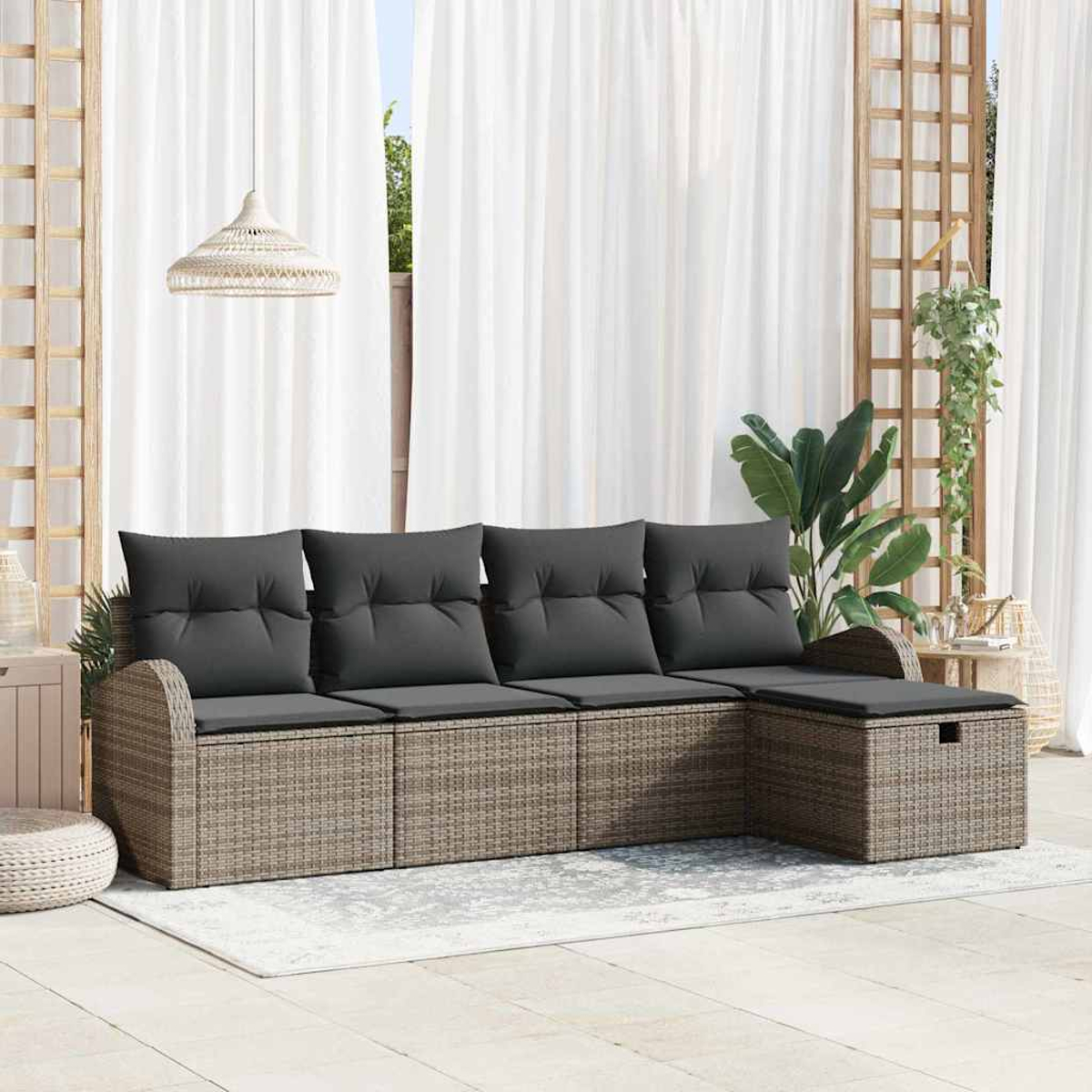 Outdoor-Ecksofa mit grauen Kissen auf einem Teppich, in der Nähe von weißen Vorhängen und Pflanzen. Inklusive Hocker.
