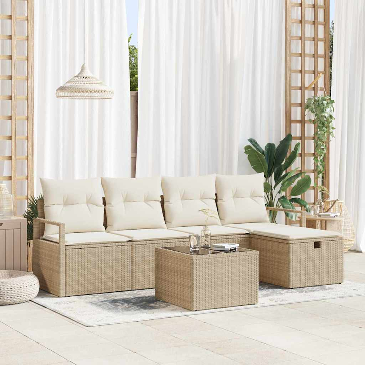 Asientos al aire libre con cojines beige, una mesa de centro y un reposapiés. Cortinas blancas y una lámpara colgante son visibles en el fondo.