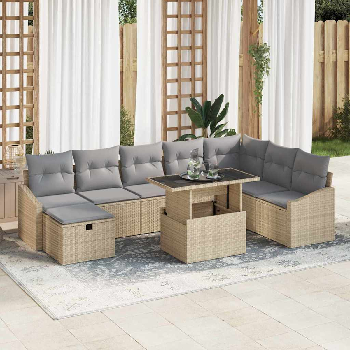 Gartenmöbel-Set aus Korbgeflecht mit grauen Kissen. Enthält ein Ecksofa und einen Couchtisch auf einem gemusterten Teppich.