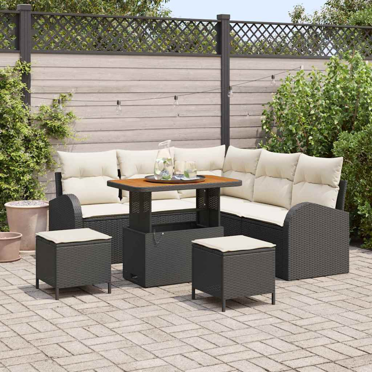 Garten-Set mit Ecksofa, zwei Hockern und einem Tisch. Das Set ist grau mit beigen Kissen, auf einer Ziegelterrasse.