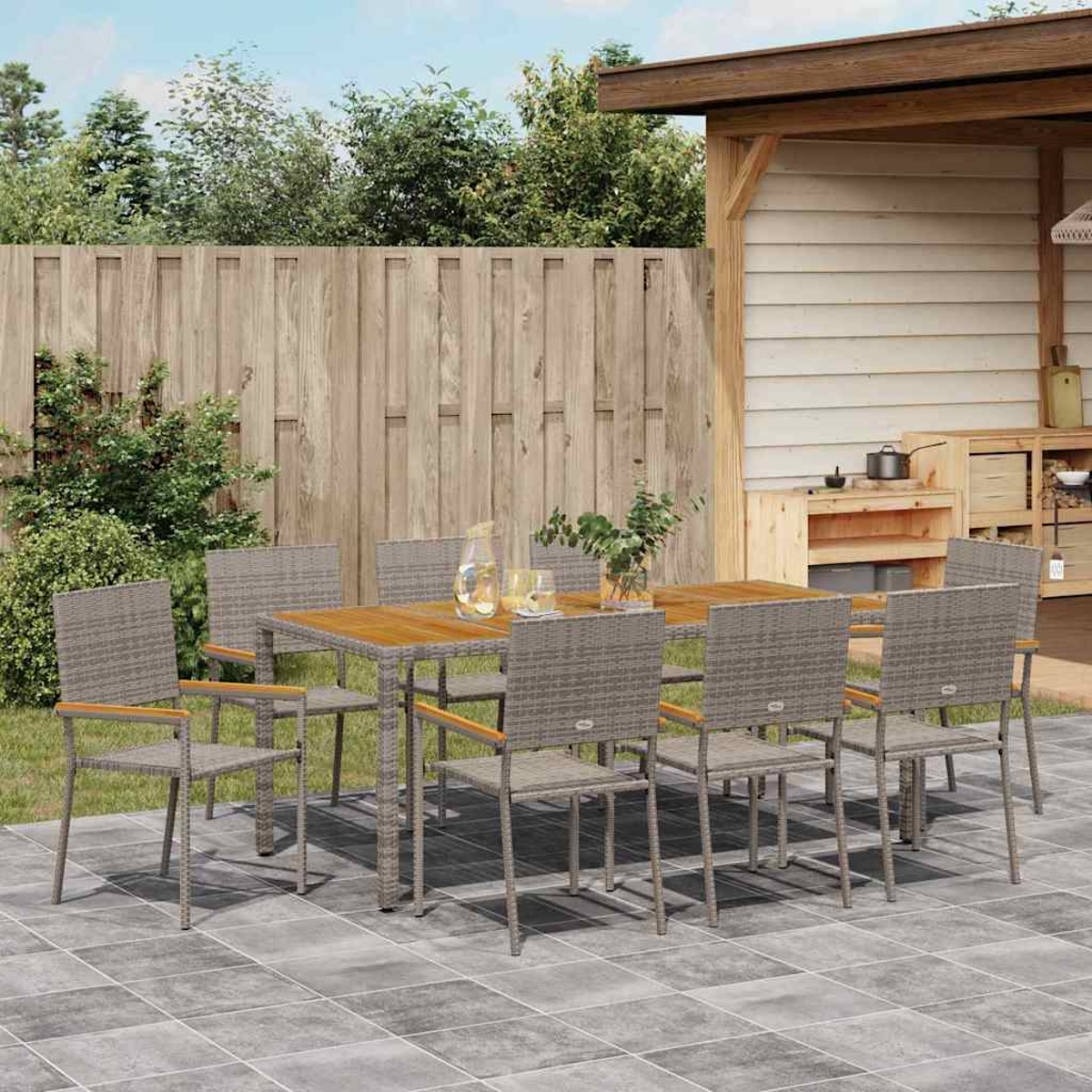 Ein Holztisch mit acht Stühlen steht auf einer Terrasse. Ein Holzzaun und Pflanzen befinden sich im Hintergrund.