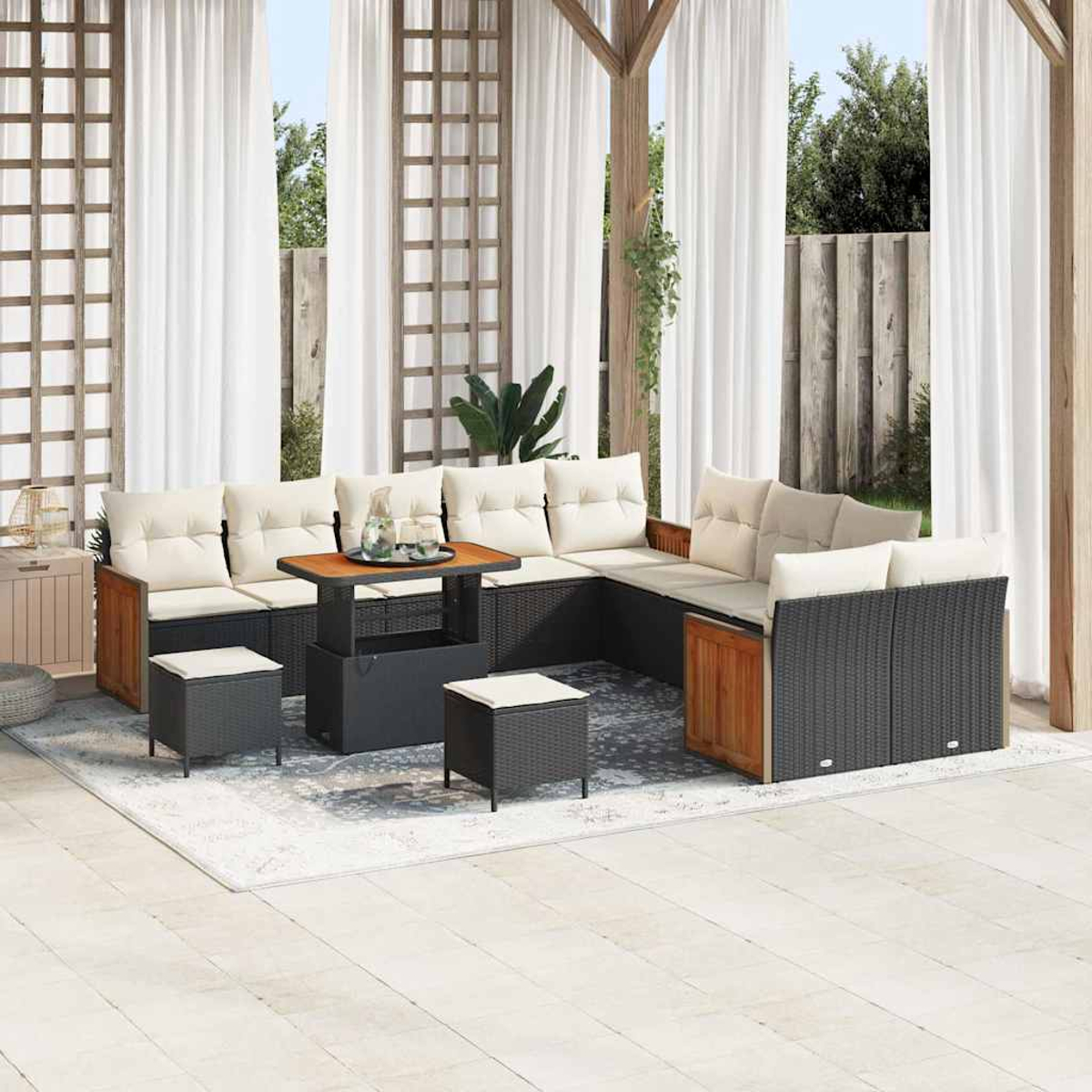 Outdoor-Sitzbereich mit Ecksofa, Couchtisch und Hockern. Weiße Vorhänge und Holzstruktur im Hintergrund.