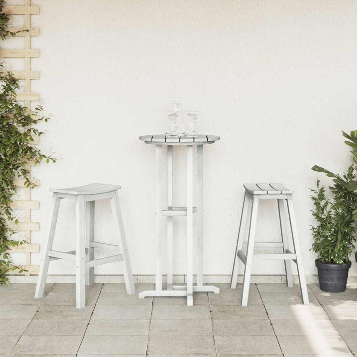 Eine graue Szene im Freien mit einem Tisch, zwei Hockern und Pflanzen. Auf dem Tisch stehen zwei Gläser.