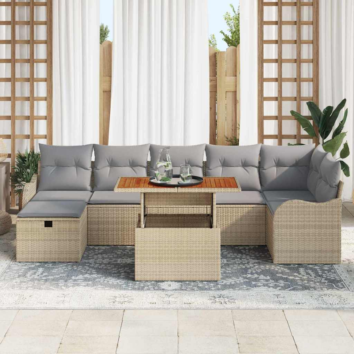 Outdoor-Ecksofa mit grauen Kissen und einem Holztisch mit Getränken, auf einem gemusterten Teppich, mit Vorhängen und Pflanzen.