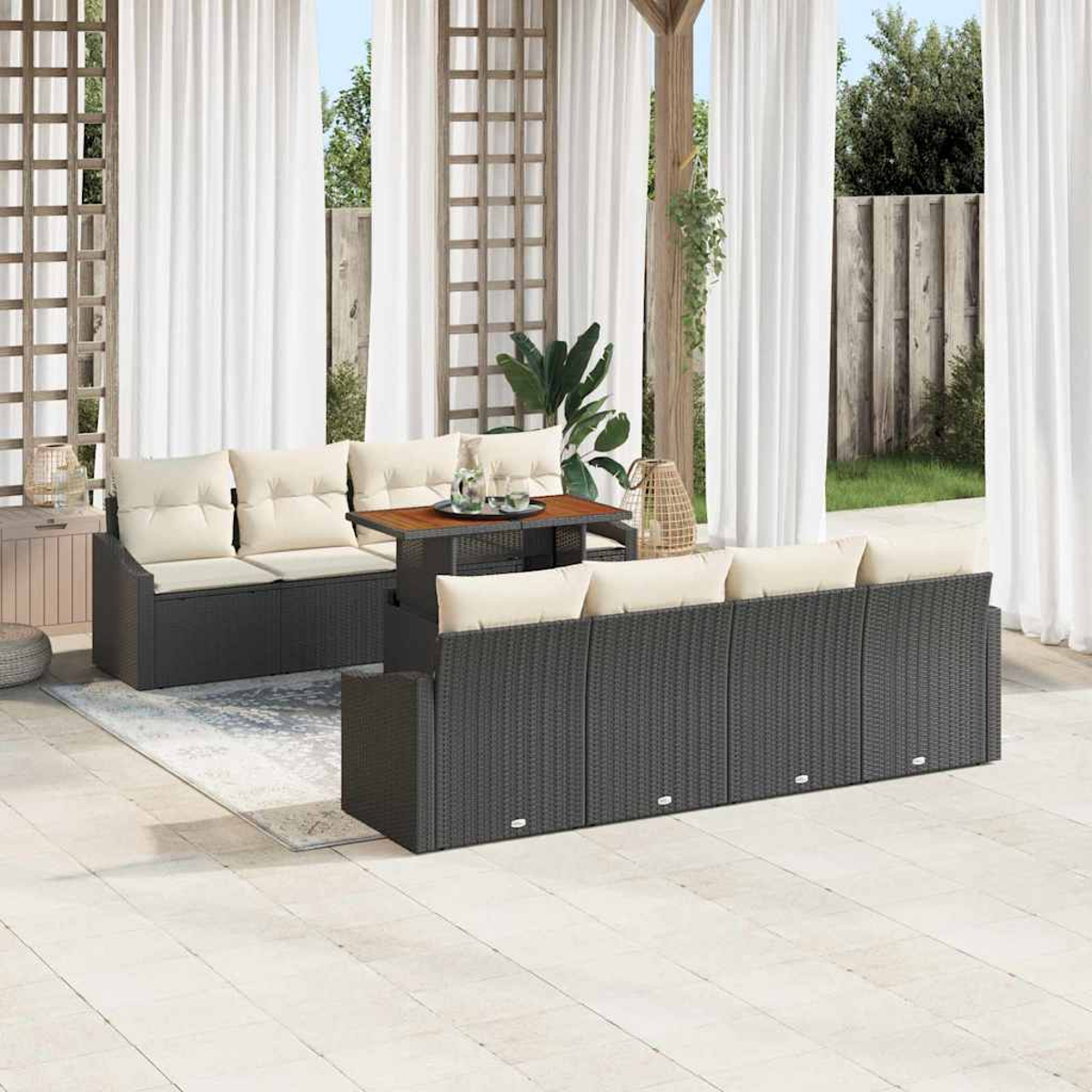 Juego de patio al aire libre con muebles de mimbre gris oscuro. Incluye sofá, sofá de dos plazas y mesa con cojines crema, cortinas al fondo.