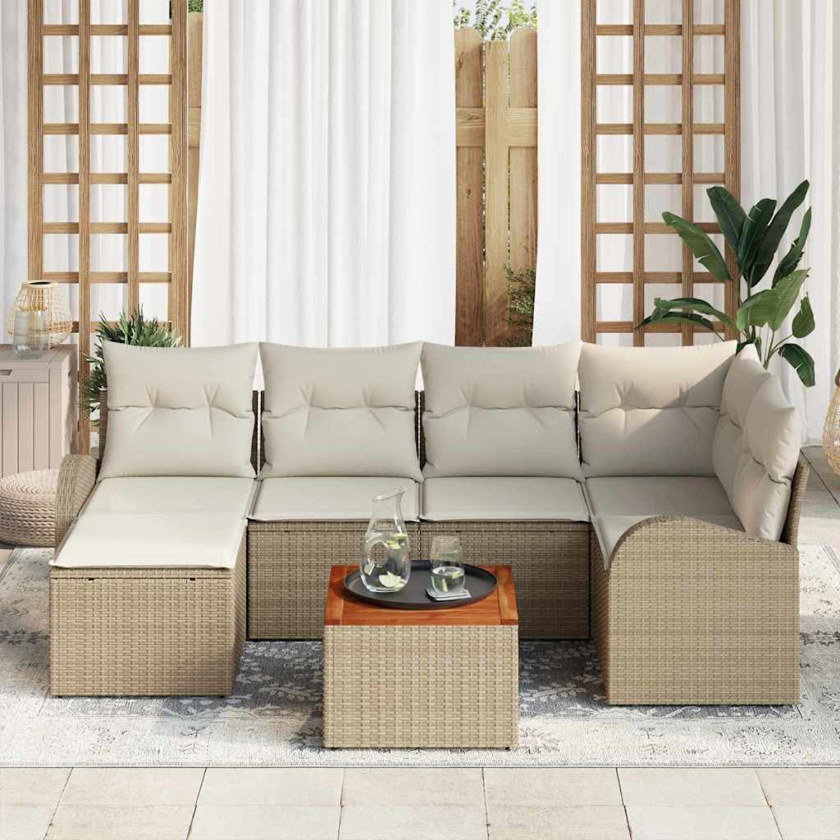 Outdoor-Ecksofa mit beigen Kissen und gewebtem Korbgewebe. Ein kleiner Tisch mit Tablett und Glas Wasser. Vorhänge und Pflanzen.