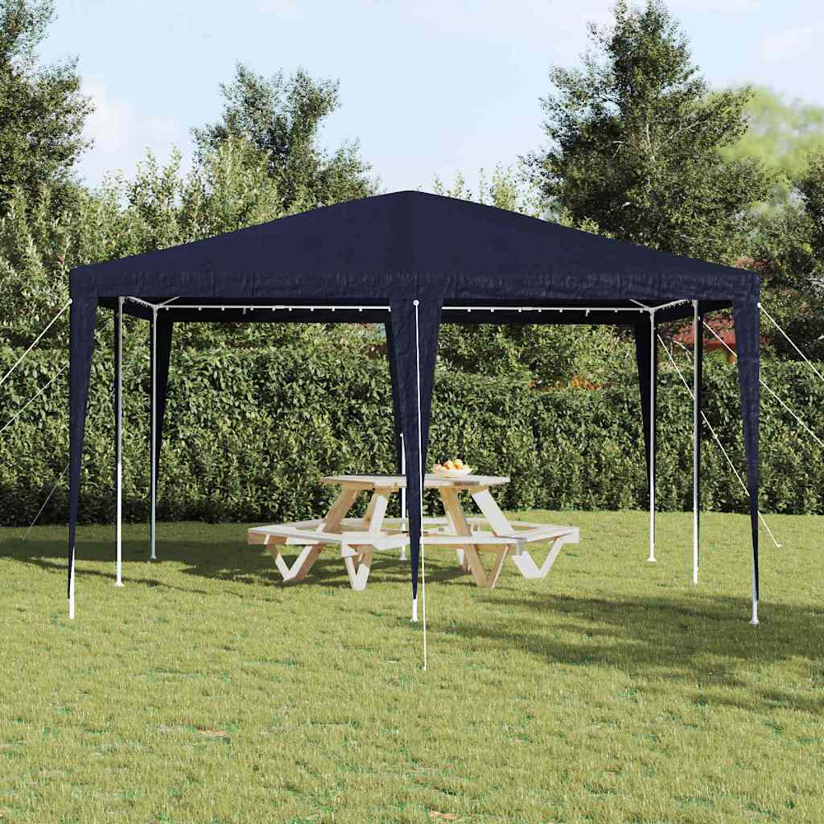 Un gazebo blu navy si trova su erba verde con un tavolo da picnic all'interno. Alberi e cespugli fanno da sfondo.