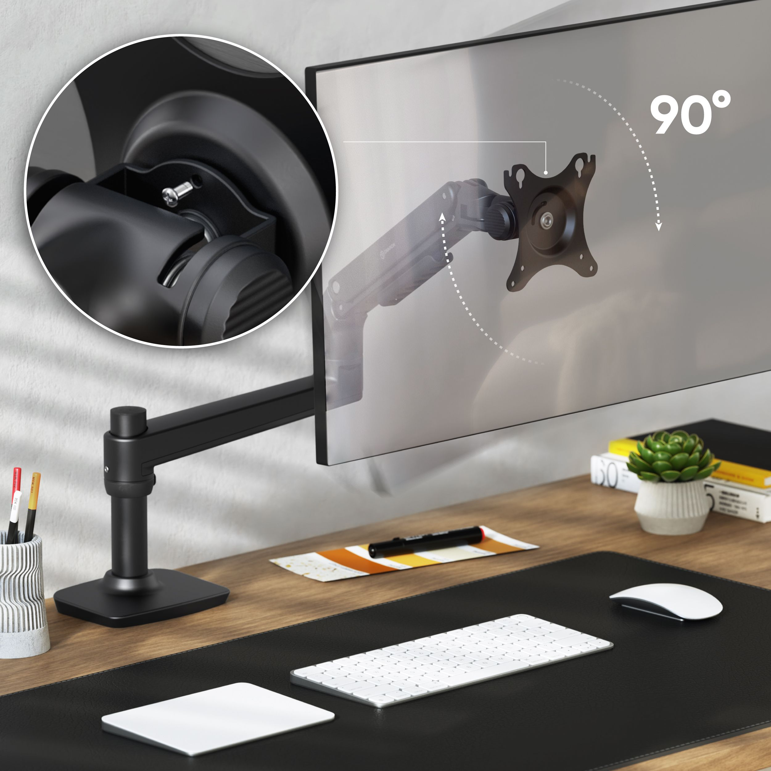 Gezeigt wird ein schwarzer Monitorarm. Ein Monitor ist an dem Arm befestigt. Ein Schreibtisch mit Tastatur und Maus.
