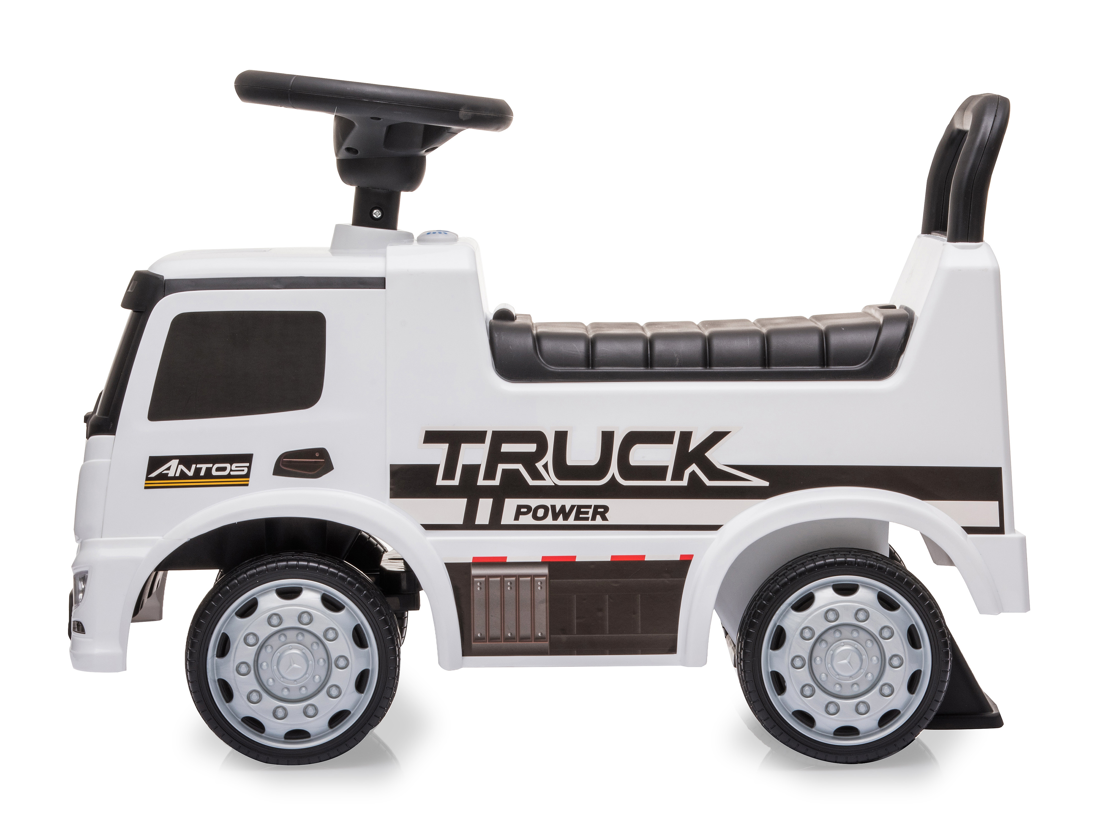 Biała zabawka ciężarówka z czarnymi akcentami. Ma kierownicę, siedzenie i duże koła. Widoczne są słowa 'Truck Power'.