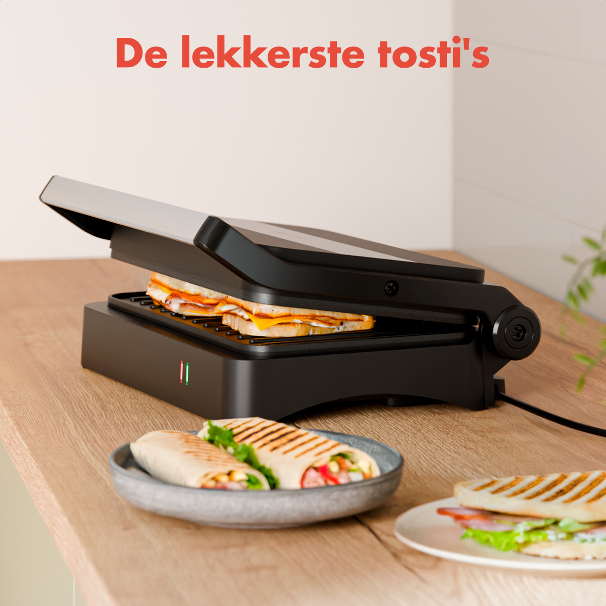 A sandwich maker with a sandwich inside. Two wraps on a plate and a sandwich on a plate. Text says 'De lekkerste tosti's'.