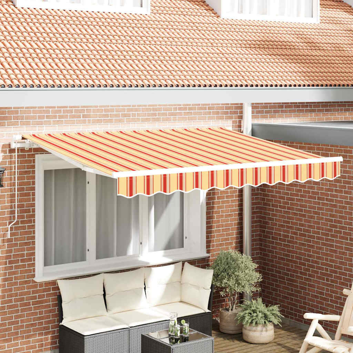 Ein Haus mit gestreifter Markise, Fenster und Sofa. Es gibt Pflanzen in Töpfen und eine Ziegelmauer.
