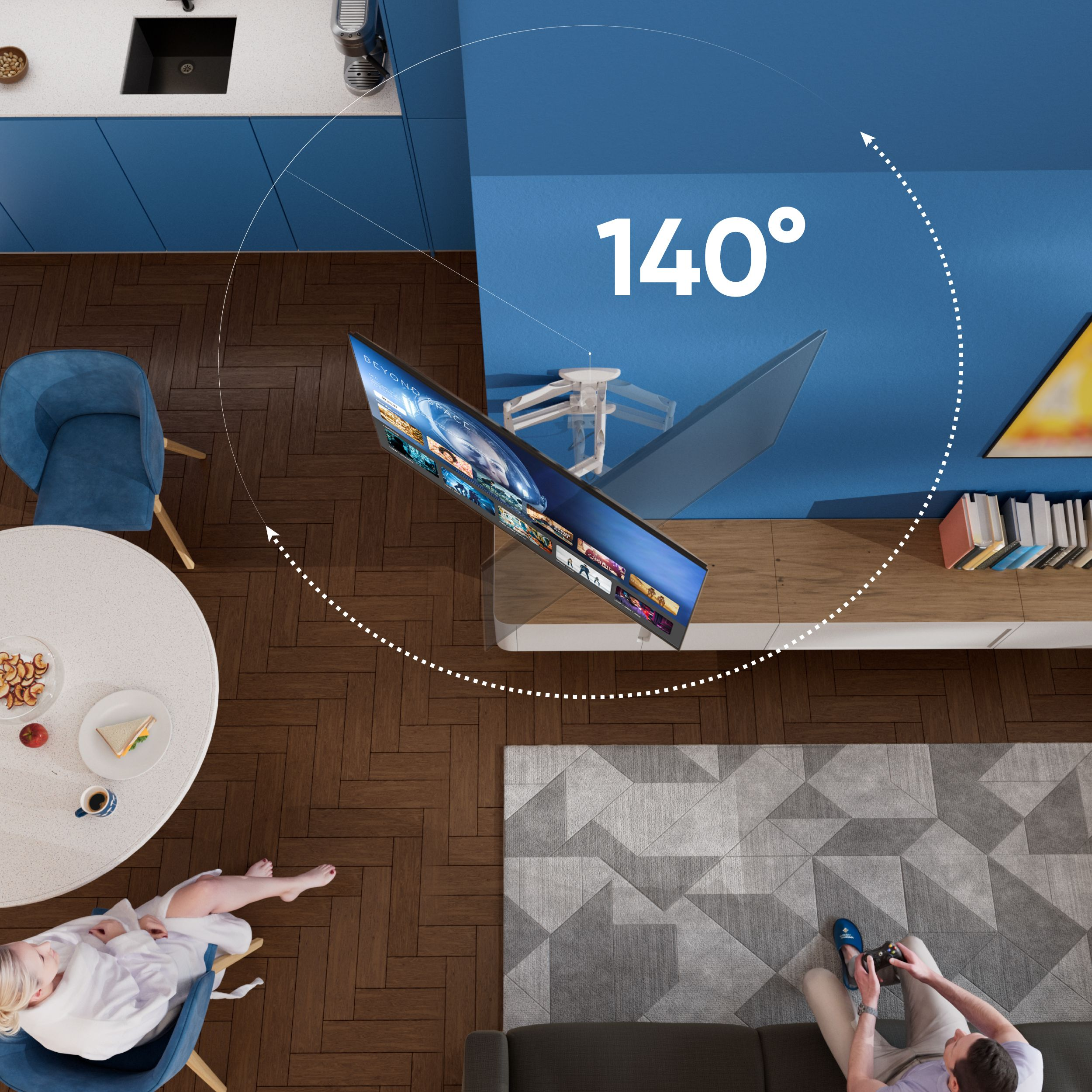 Widok z góry na salon z telewizorem, sofą, osobą grającą, kobietą na krześle i stołem z jedzeniem.