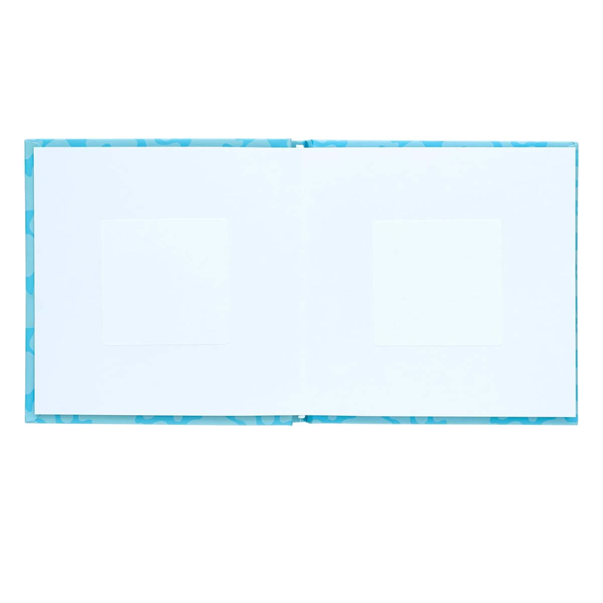 Album photo ouvert avec pages blanches vierges, couverture bleue à motifs et deux emplacements rectangulaires pour photos.
