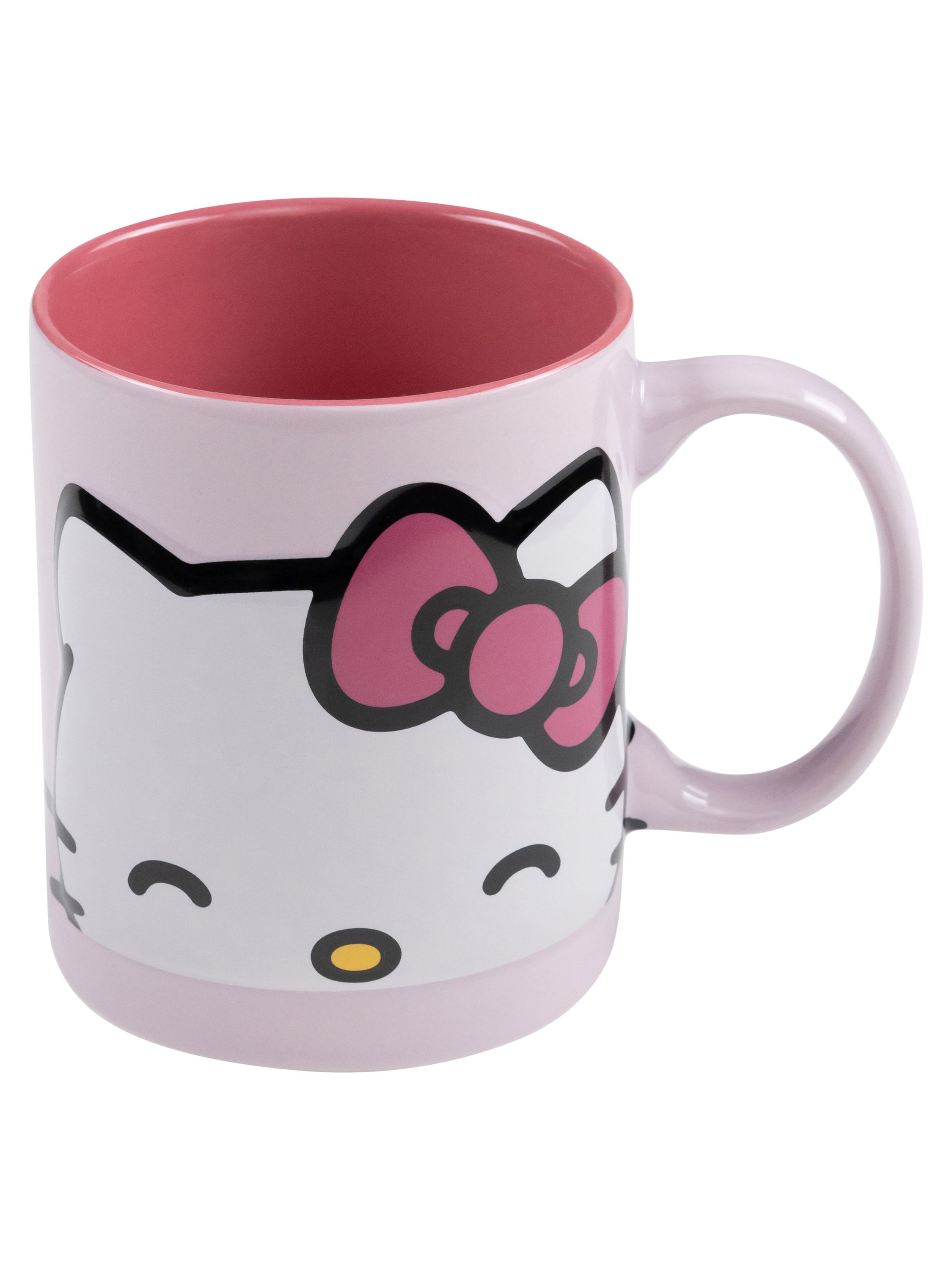 Eine rosa Hello Kitty-Tasse mit dem Gesicht der Figur darauf. Innen rosa, Griff rechts.