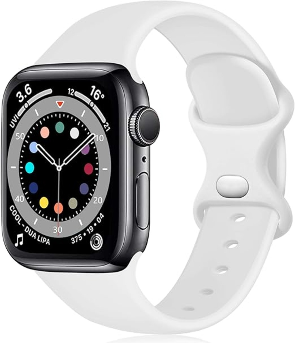 Eine schwarze Apple Watch mit weißem Armband. Das Zifferblatt zeigt Zeit und bunte Indikatoren. Der Hintergrund ist weiß.