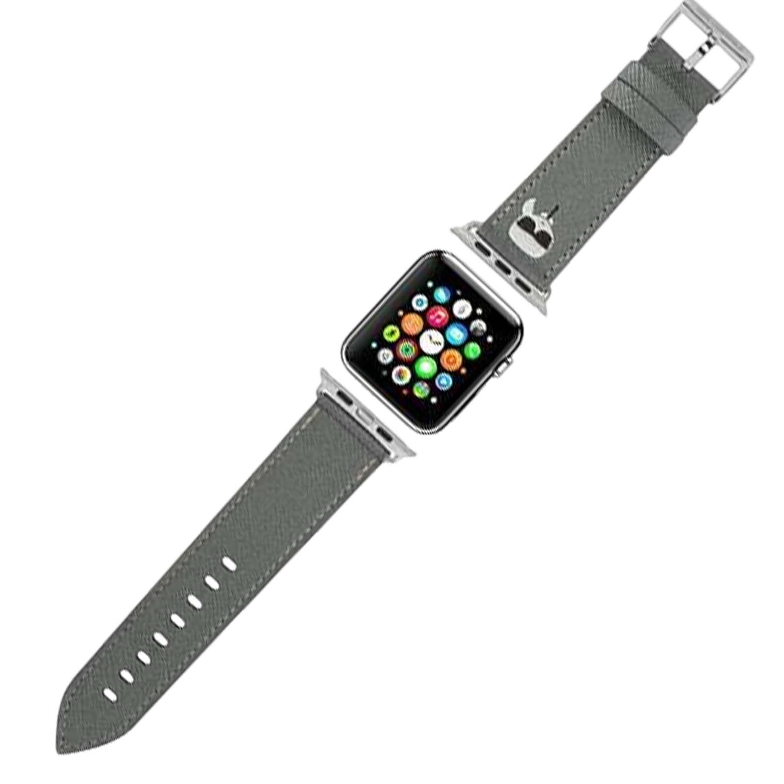 Apple Watch con correa gris. La esfera muestra iconos coloridos de aplicaciones. La correa tiene una hebilla y un pequeño diseño blanco.
