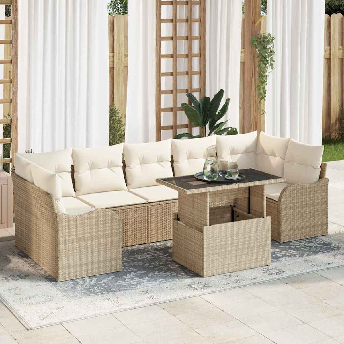 Terrassenmöbel-Set mit cremefarbenen Kissen und Korbmöbeln. Tisch mit Gläsern und Krug. Weiße Vorhänge im Hintergrund.