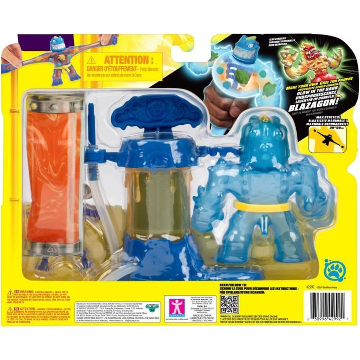 Ein Blazagon-Spielzeugset. Es hat eine blaue Figur, einen Behälter mit oranger Flüssigkeit und eine blaue Maschine. Die Box ist gelb.
