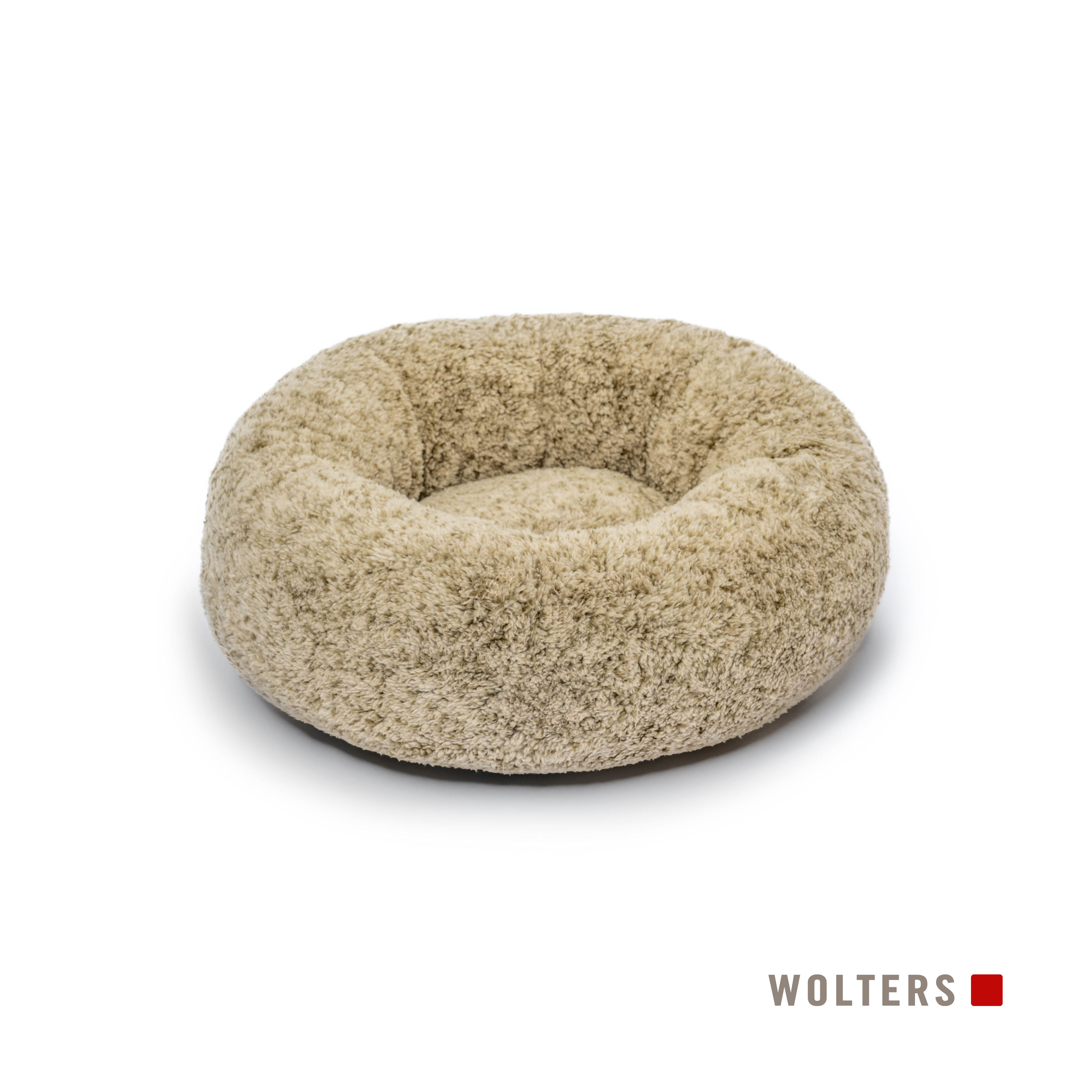 Ein beiges und rundes Hundebett liegt auf einer weißen Oberfläche. Das Bett hat eine weiche, flauschige Textur.