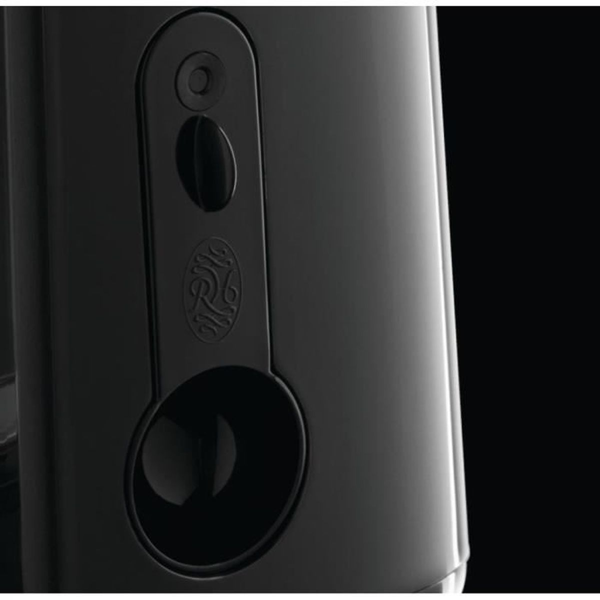 Zbliżenie czarnego urządzenia. Posiada panel sterowania z przyciskami i element dekoracyjny. Tło jest czarne.