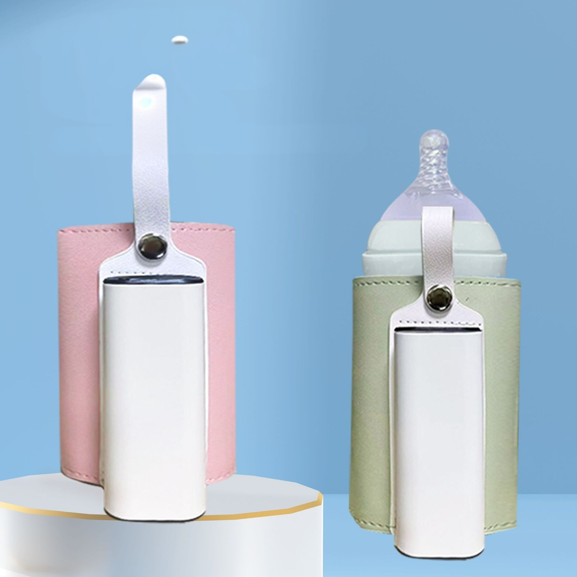 Zwei Babyflaschenwärmer, rosa und grün, mit weißen Akzenten, stehen vor einem blauen Hintergrund. Ein weißes Objekt schwebt darüber.