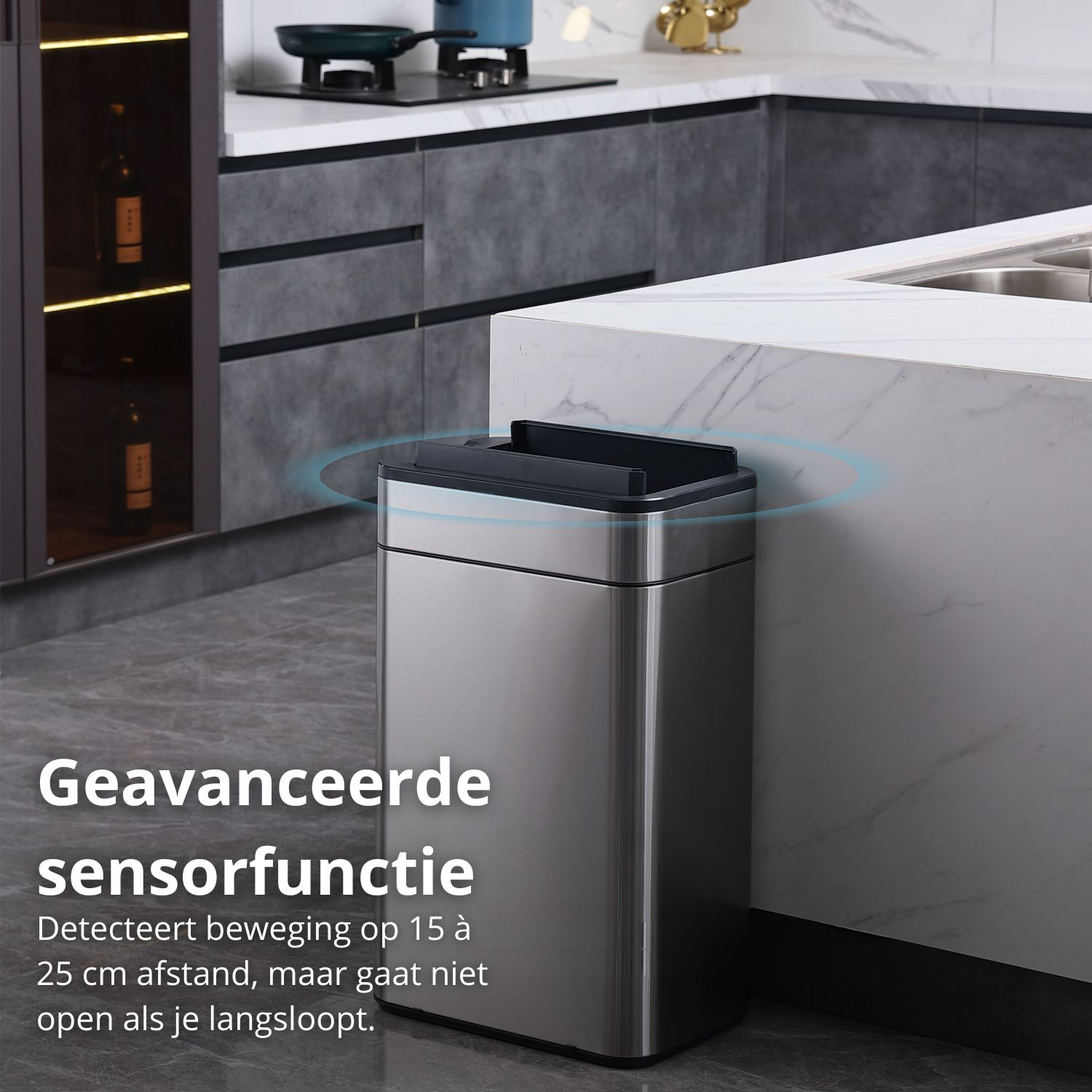 A stainless steel trash can with a black lid is in a modern kitchen. Text says it detects motion.