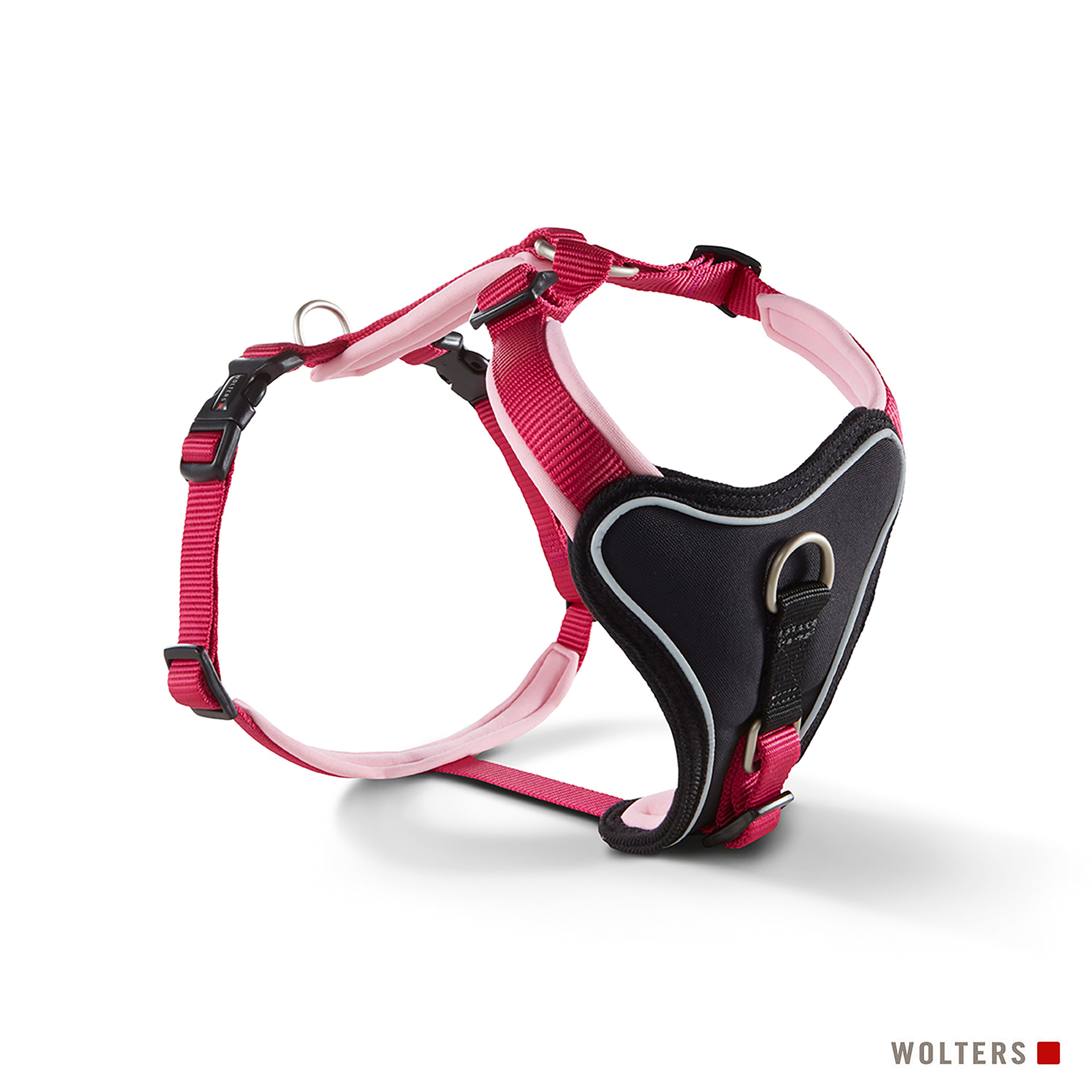 Rotes und schwarzes Hundegeschirr. Es hat eine schwarze Brustplatte, rote Riemen und ein hellrosa Innenfutter.