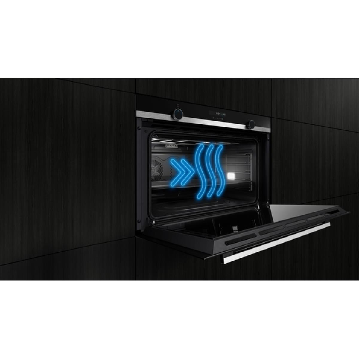 An open oven shows blue airflow lines. The oven door is open, revealing the interior. Black cabinetry frames the oven.