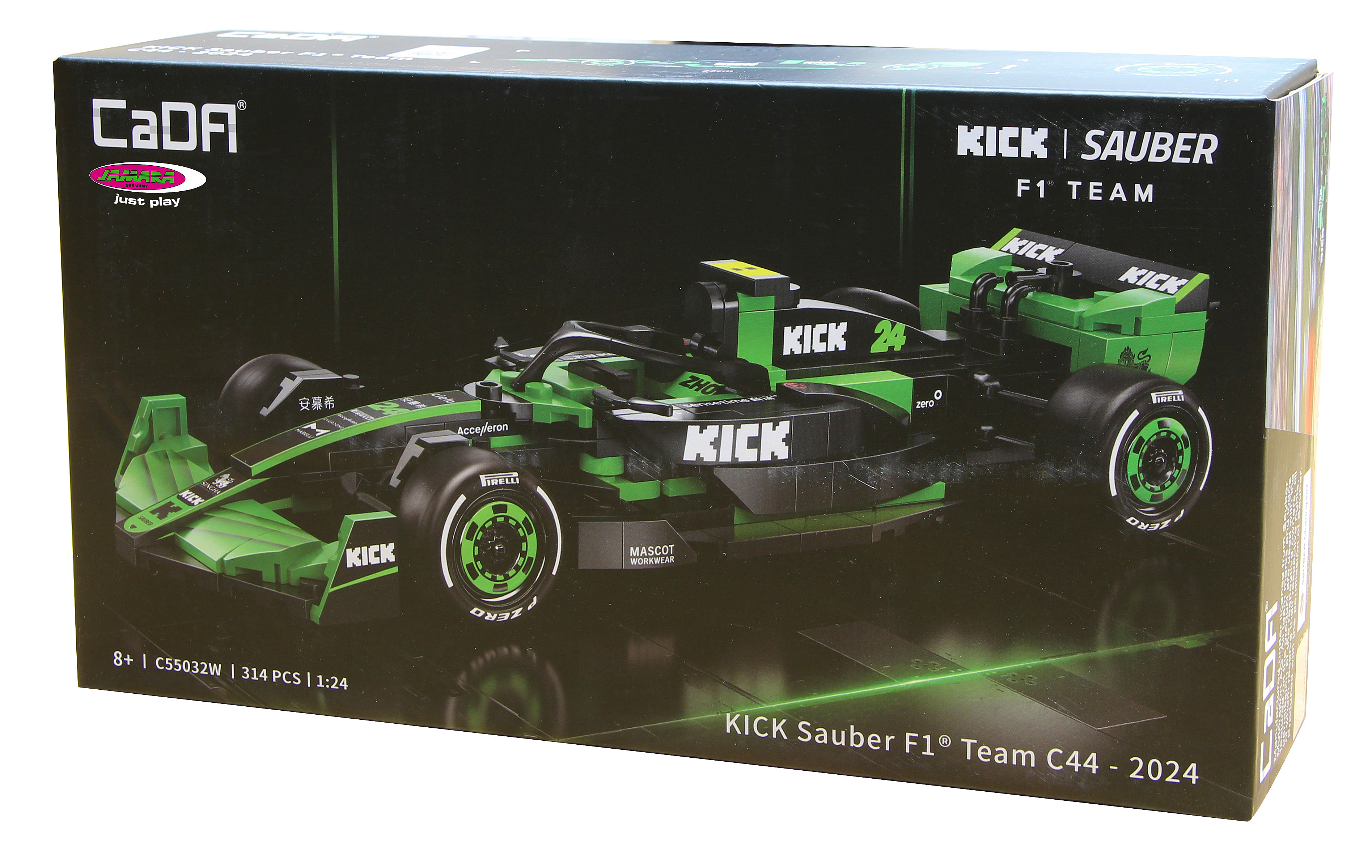 Eine Schachtel zeigt ein grünes und schwarzes Spielzeug-Rennauto mit der Aufschrift 'KICK Sauber F1 Team'. Die Schachtel ist schwarz mit Text.