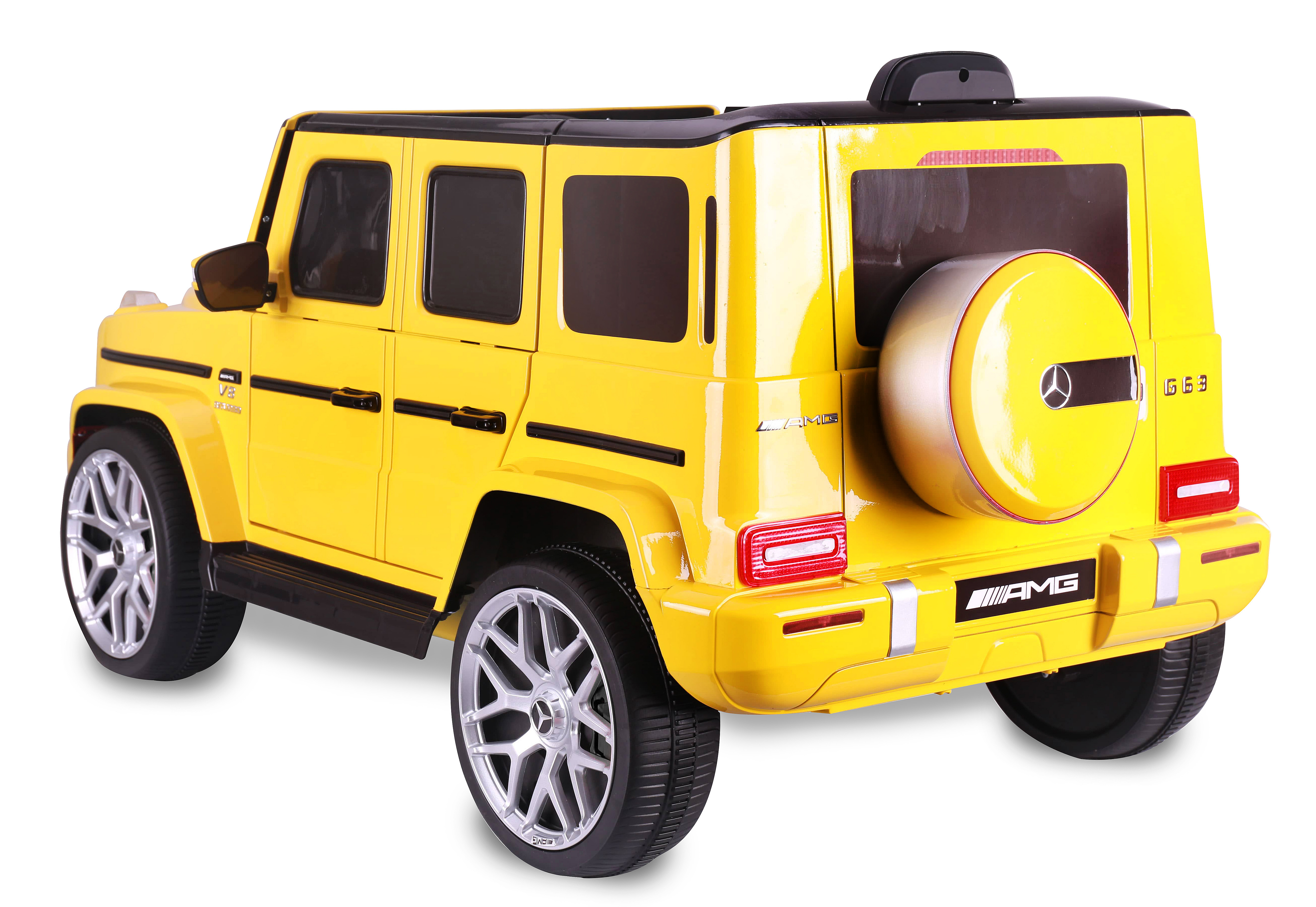 Ein gelber Spielzeug-SUV mit schwarzen Details und silbernen Rädern. Es hat AMG-Branding und ein Ersatzrad hinten.