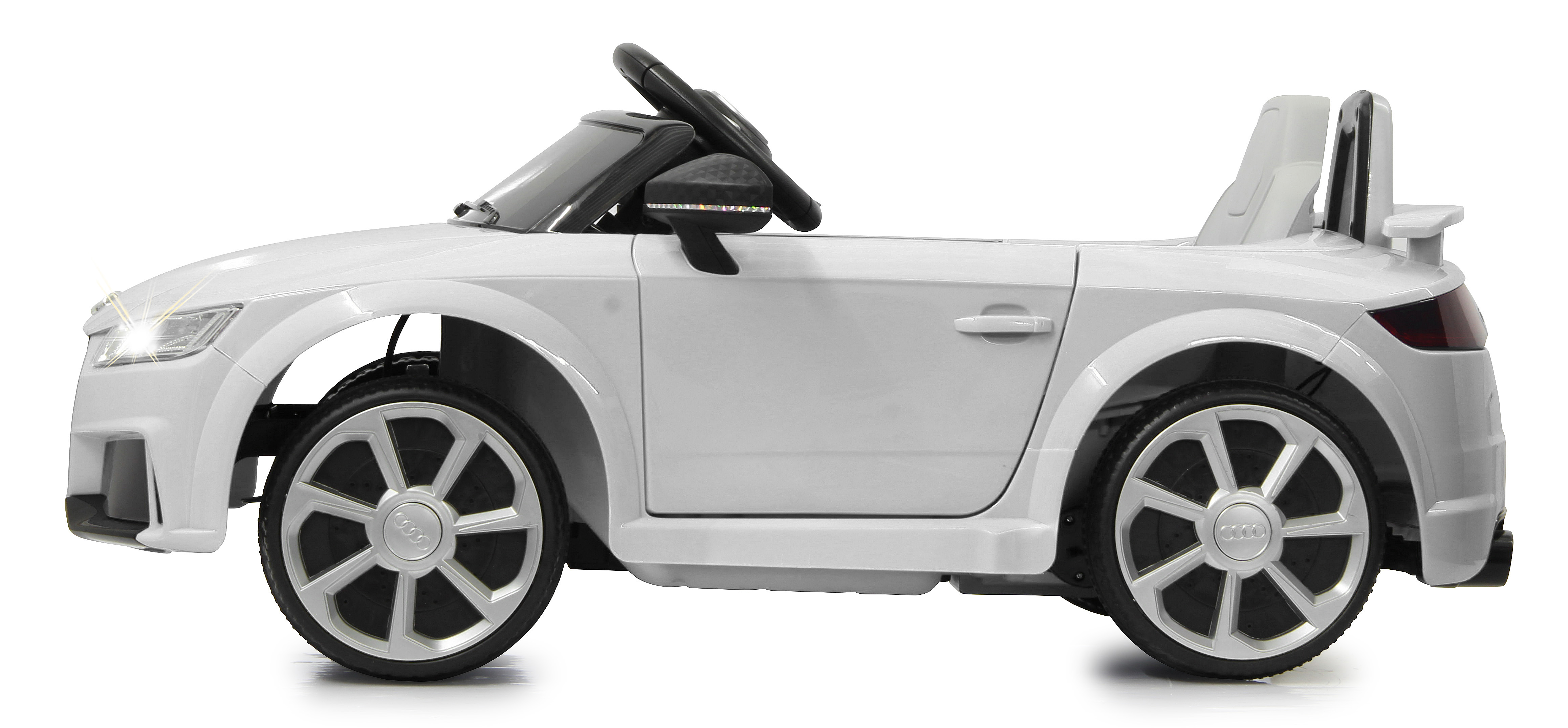 Un coche de juguete blanco, parecido a un Audi TT, se muestra sobre un fondo blanco. Los faros están encendidos. El coche es un modelo convertible.