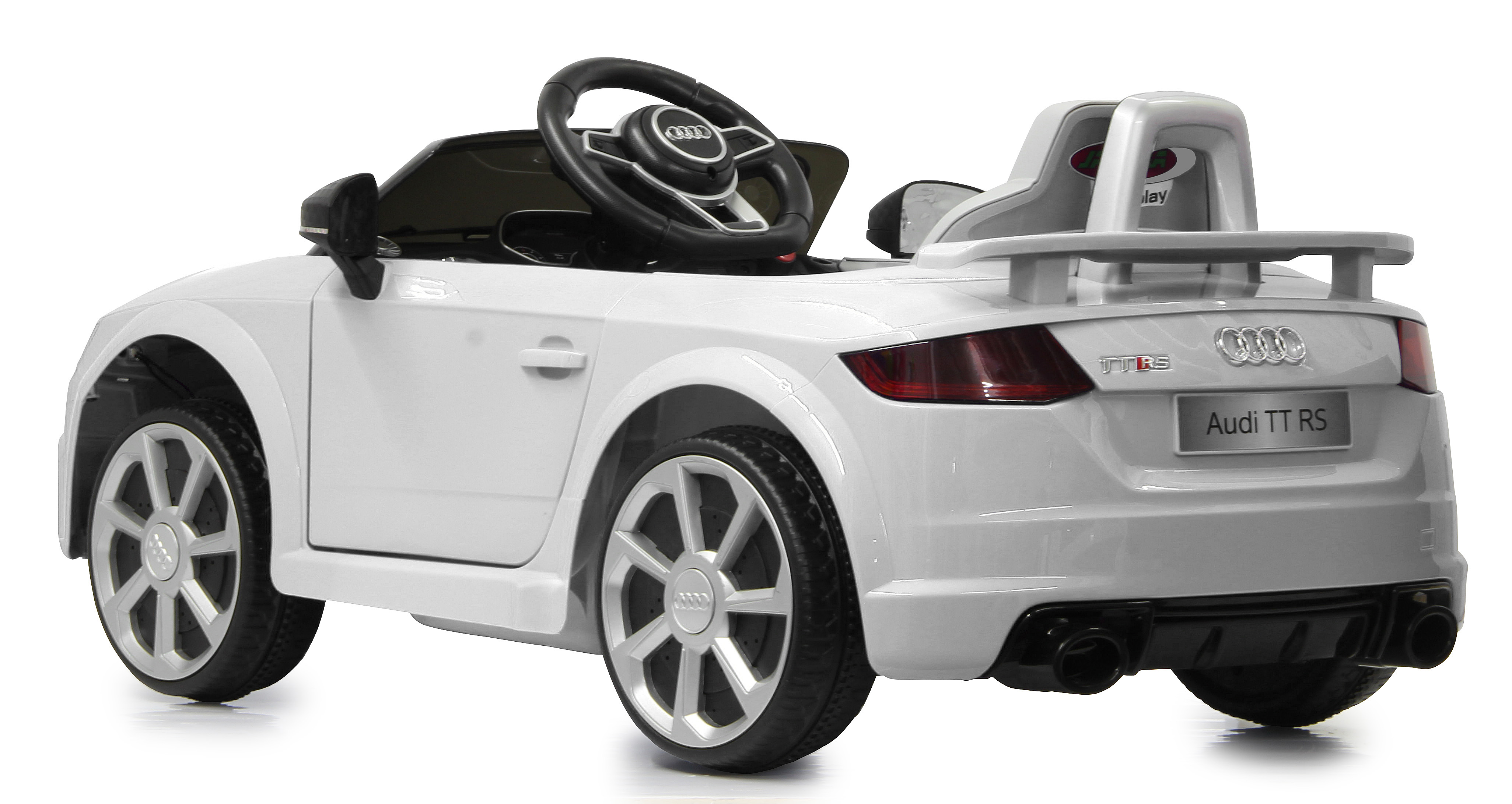 Un coche de juguete Audi TT RS blanco con ruedas negras. Tiene un volante negro y el logo de Audi. El fondo es blanco.