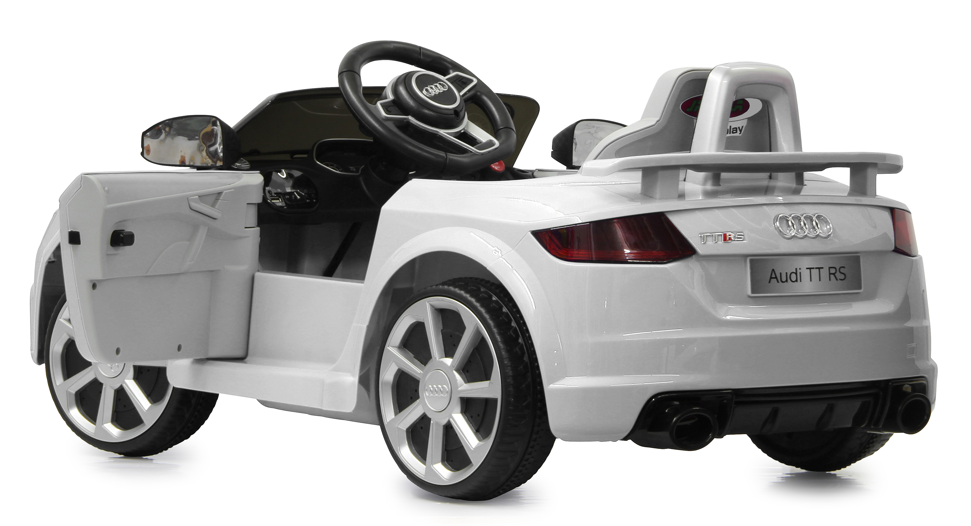 Coche infantil Audi TT RS blanco. Cuenta con puerta abierta, volante negro y llantas detalladas. El coche está sobre fondo blanco.