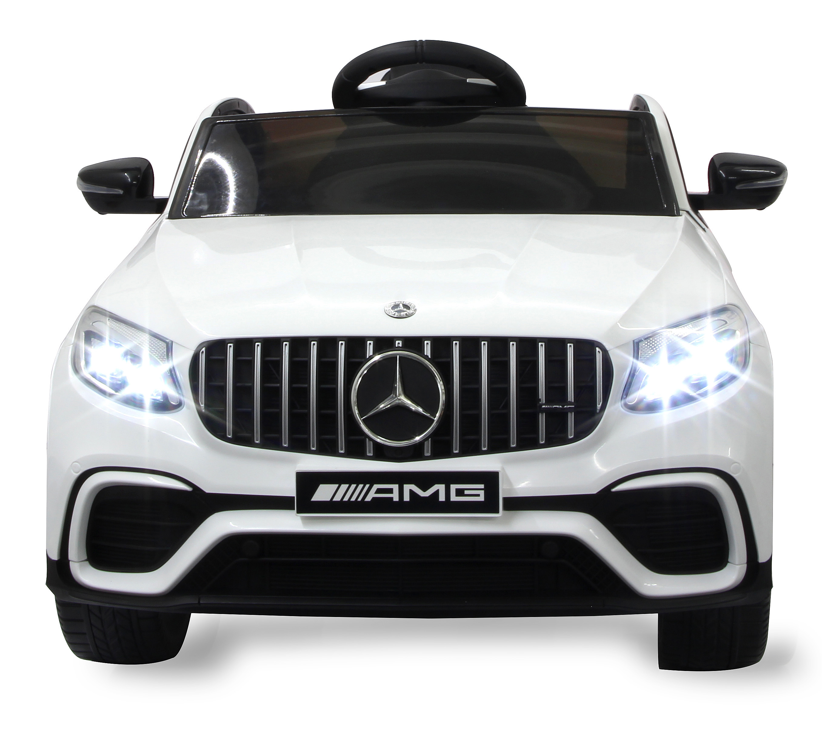 Ein weißes Spielzeugauto mit schwarzen Akzenten. Es hat helle Scheinwerfer, einen schwarzen Grill mit Mercedes-Logo und AMG-Emblem.