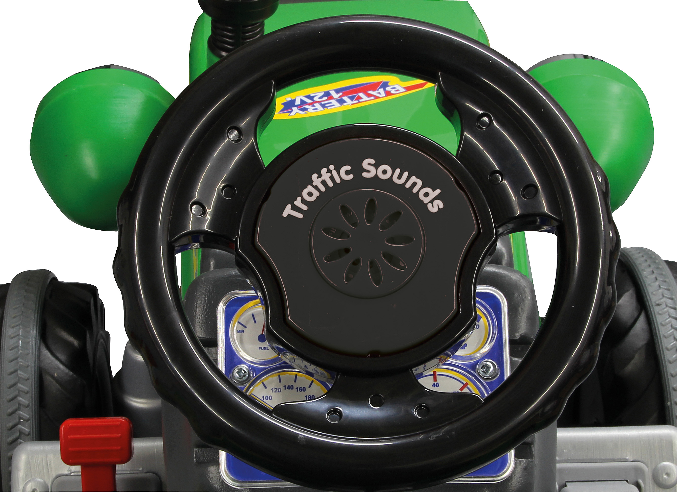 Nahaufnahme eines Spielzeugauto-Lenkrads. Es ist schwarz mit dem Text "Traffic Sounds". Grüne Lichter, Anzeigen und ein roter Hebel sind sichtbar.