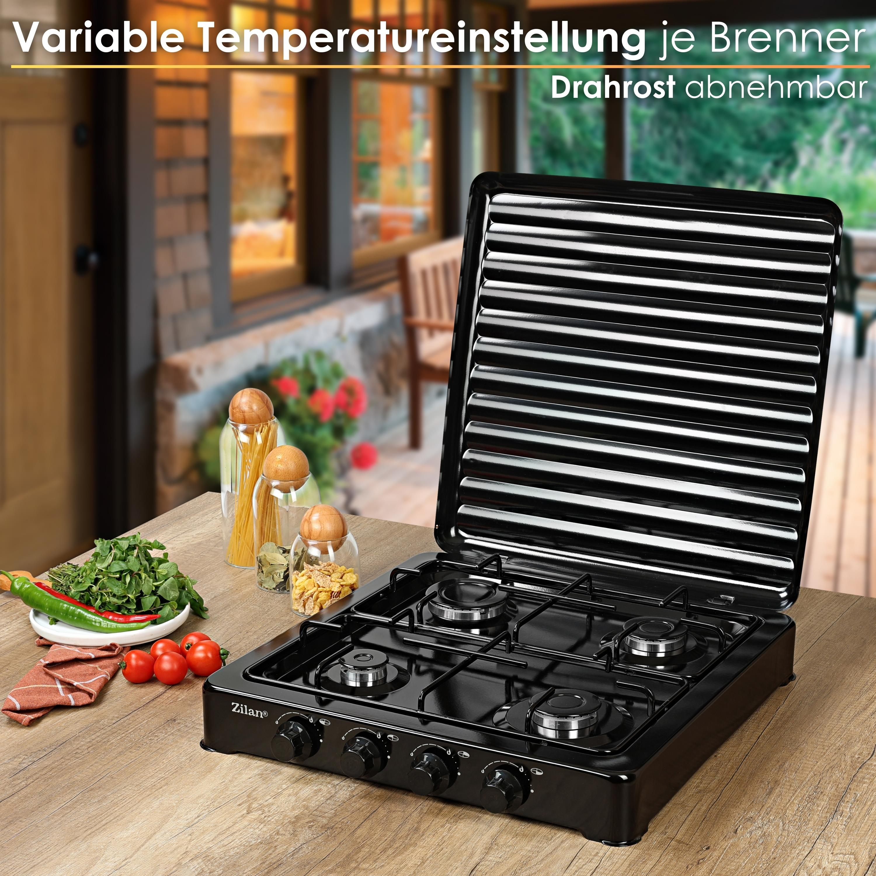 Czarna kuchenka gazowa z czterema palnikami. Zioła, pomidory i makaron na drewnianym stole. Tło to rozmyta scena na zewnątrz.
