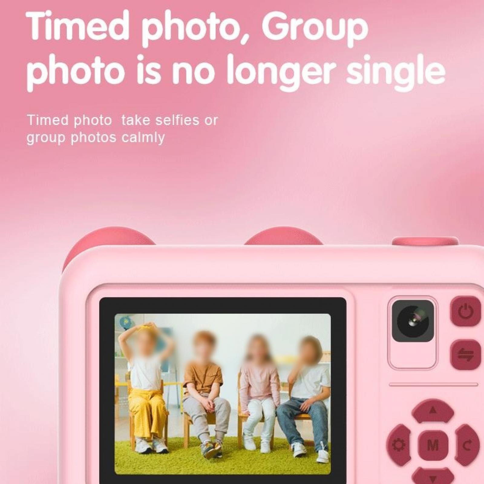 Eine rosa Kamera zeigt ein Foto von vier verschwommenen Kindern auf Stühlen. Der Text lautet 'Zeitgesteuertes Foto, Gruppenfoto'.