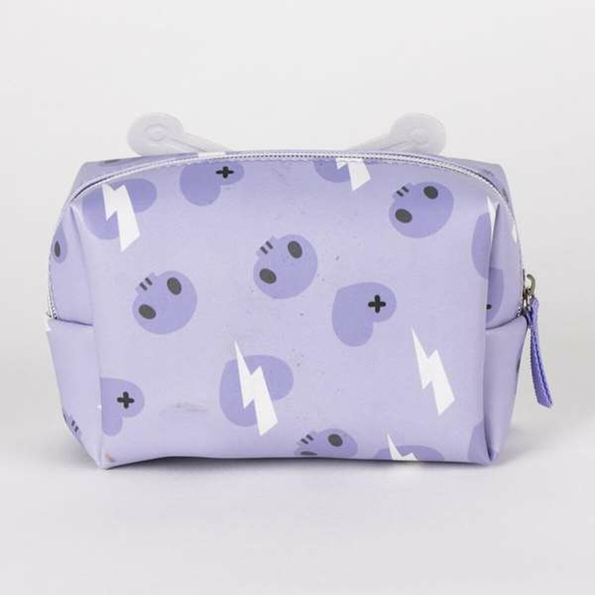 A purple cosmetic bag with a pattern of skulls, lightning bolts, and crosses. It has a zipper and white handles.