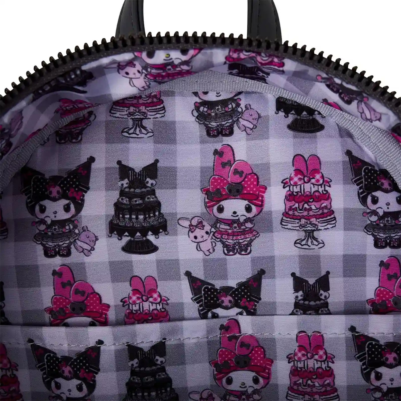 Im Inneren eines schwarzen Rucksacks: ein Schachbrettmuster mit Zeichentrickfiguren und Kuchen in Pink, Schwarz und Weiß.
