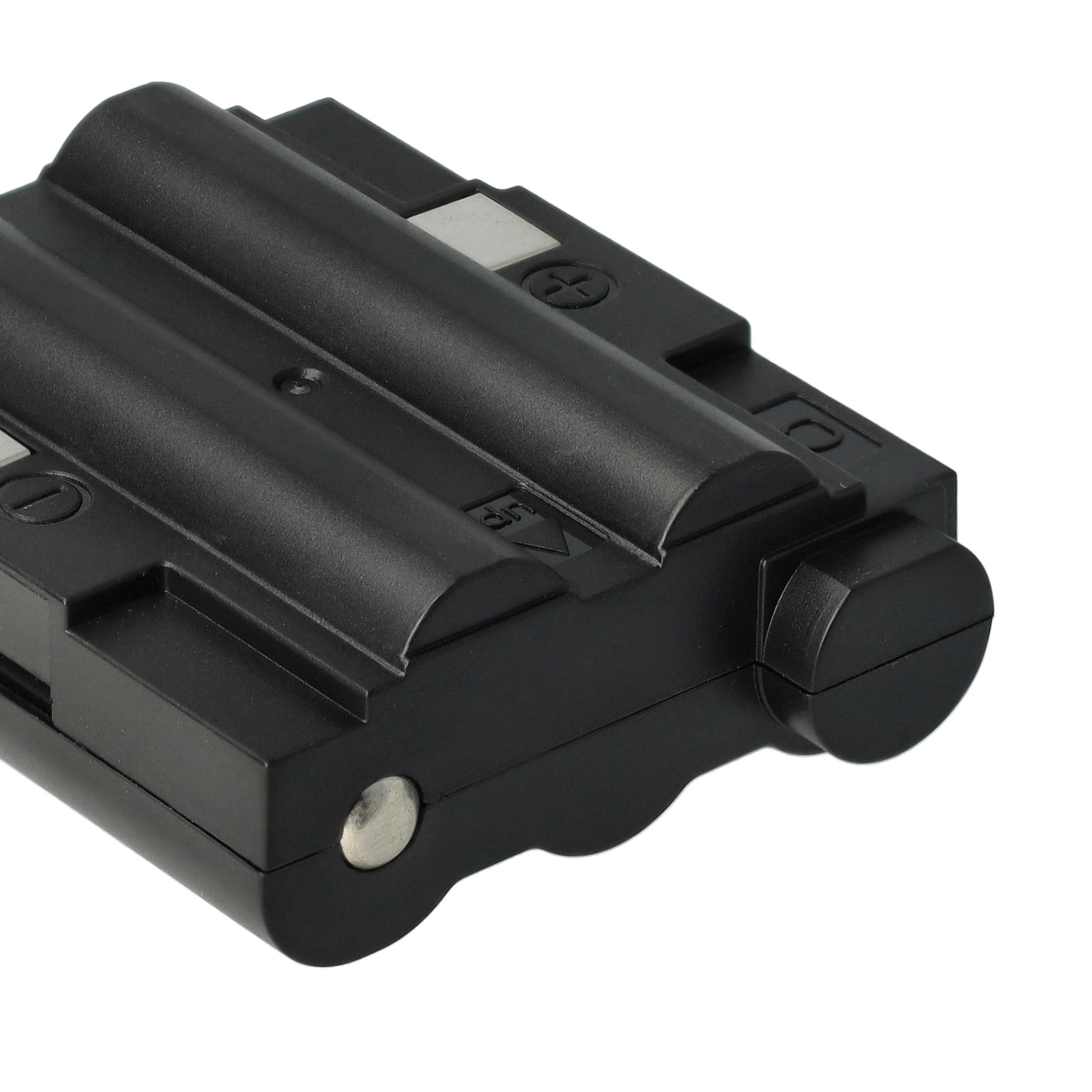 Ein schwarzes Batteriepack mit geriffelter Oberseite, Metallkontakten und einem kreisförmigen Ende.